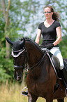 woman rides Hessian Warmblood