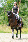 woman rides Hessian Warmblood