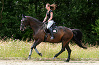 woman rides Hessian Warmblood