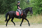 woman rides Hessian Warmblood