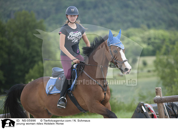 young woman rides Holstein Horse / NS-05996