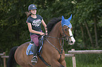 young woman rides Holstein Horse