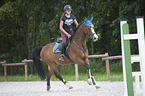 young woman rides Holstein Horse