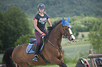 young woman rides Holstein Horse