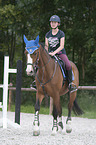 young woman rides Holstein Horse