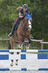 young woman rides Holstein Horse