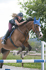 young woman rides Holstein Horse