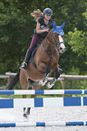 young woman rides Holstein Horse