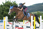 young woman rides Holstein Horse