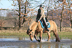 woman rides Icelandic horse