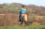 woman rides Icelandic horse