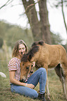 woman and Icelandic horse foal