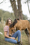 woman and Icelandic horse foal