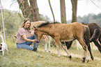woman and Icelandic horse foals