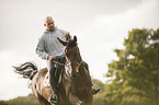 man rides Mecklenburg Warmblood