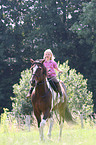 girl rides Paint Horse