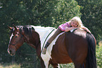 girl rides Paint Horse