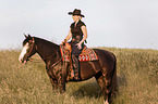 woman rides Paint Horse