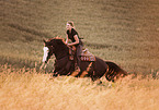 woman rides Paint Horse