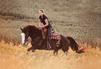 woman rides Paint Horse