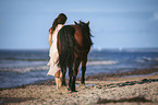 woman leads horse