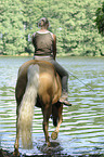 woman rides Quarter Horse