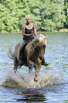 woman rides Quarter Horse