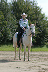 woman rides Quarter Horse