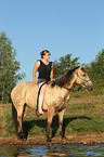 woman rides Quarter Horse