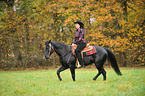 woman rides Quarter Horse