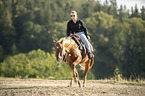 woman rides Quarter Horse