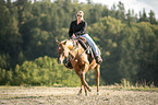 woman rides Quarter Horse