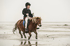 boy rides Shetland Pony