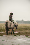 girl rides Shetland Pony