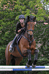 woman jumps with Trakehner