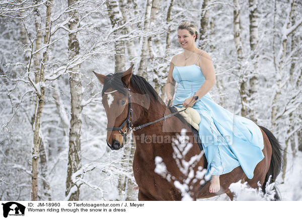 Woman riding through the snow in a dress / JM-18960