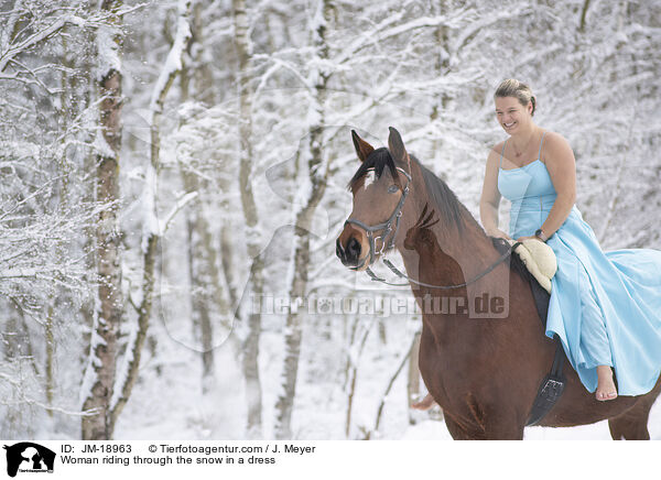 Woman riding through the snow in a dress / JM-18963