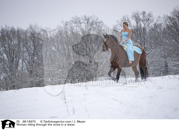 Woman riding through the snow in a dress / JM-18970