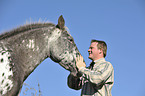 man and Appaloosa-Mix