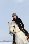 woman rides warmblood in winter