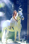 woman rides white horse