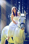 woman rides white horse