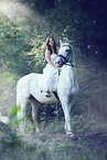 woman rides white horse