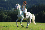 woman rides white horse