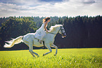 woman rides white horse