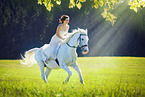 woman rides white horse