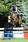 girl jumps with Welsh Pony