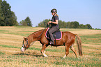 woman rides Welsh Pony