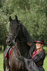 young woman with Friesian Horse