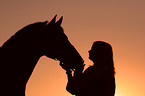 horse and woman in sundown